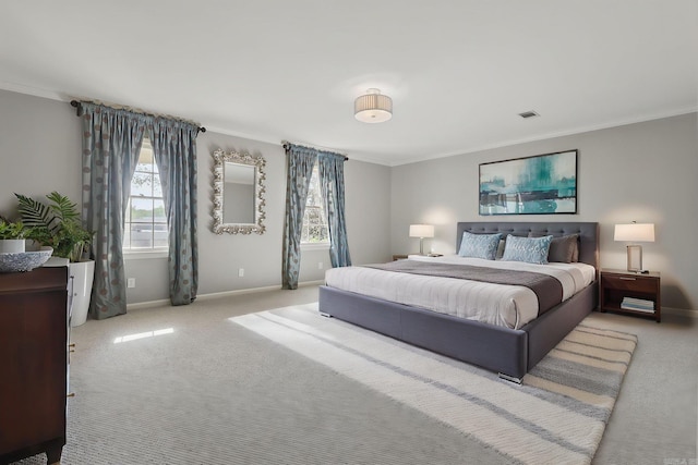 carpeted bedroom featuring baseboards, ornamental molding, and visible vents
