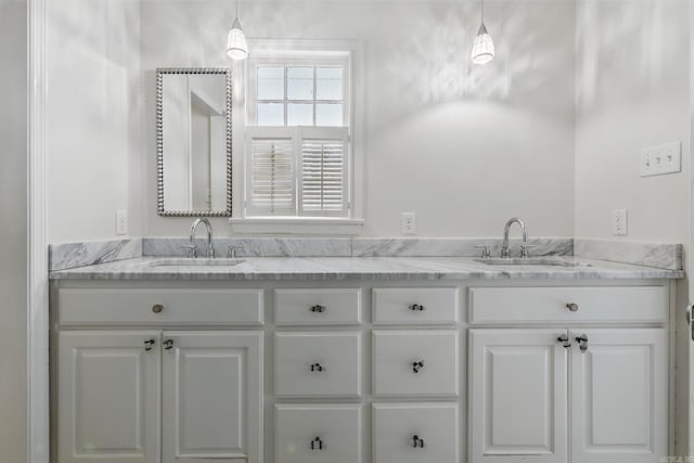 bathroom with double vanity and a sink