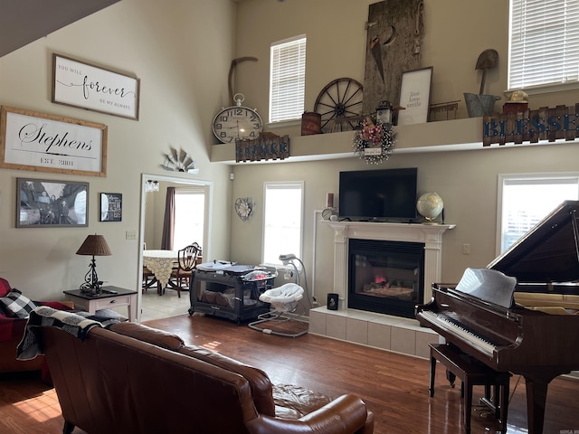 200 Blue Bird Cv, White Hall, AR 71602 - living area with a tiled fireplace, a high ceiling, and wood finished floors