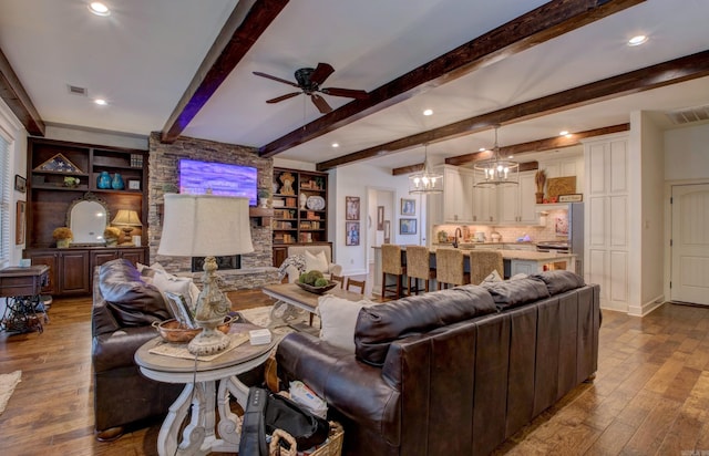 2136 Avondale, Benton, AR 72019 - living room with visible vents, baseboards, ceiling fan with notable chandelier, and dark wood-style floors