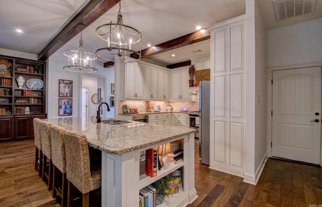 2136 Avondale, Benton, AR 72019 - kitchen featuring visible vents, open shelves, an inviting chandelier, a sink, and beam ceiling