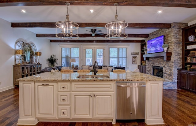 2136 Avondale, Benton, AR 72019 - kitchen with a sink, stainless steel dishwasher, light stone countertops, and a fireplace