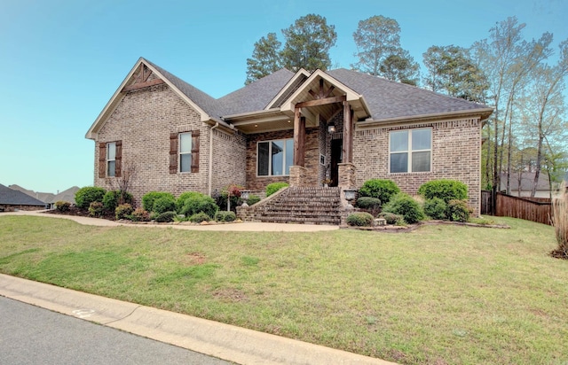 2136 Avondale, Benton, AR 72019 - view of front facade featuring a shingled roof, a front yard, fence, and brick siding
