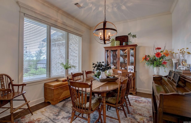 2136 Avondale, Benton, AR 72019 - dining room with visible vents, baseboards, ornamental molding, a chandelier, and wood finished floors