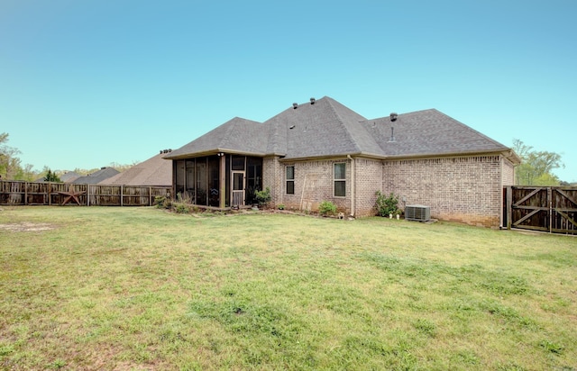 2136 Avondale, Benton, AR 72019 - rear view of property with cooling unit, a yard, a sunroom, and brick siding