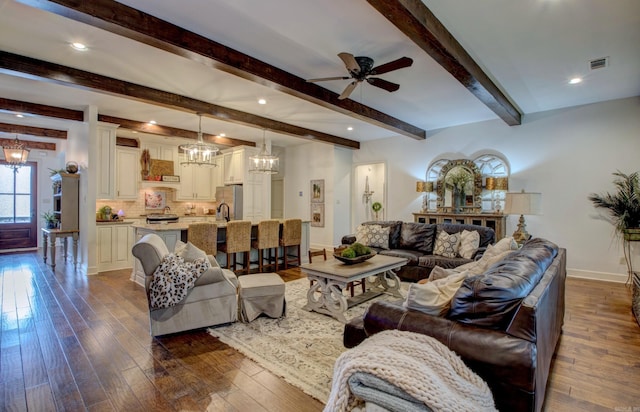 2136 Avondale, Benton, AR 72019 - living room with visible vents, baseboards, dark wood-style floors, beam ceiling, and ceiling fan with notable chandelier