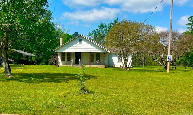 bungalow-style home featuring a carport, a chimney, and a front lawn