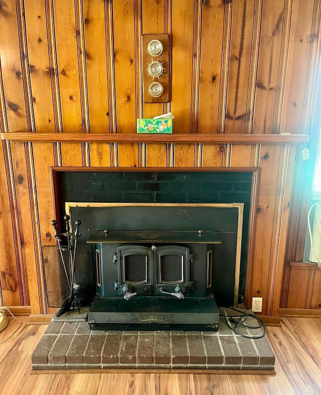 interior details featuring wood finished floors and wood walls