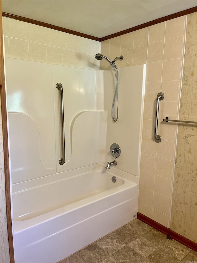 full bath with baseboards and shower / washtub combination