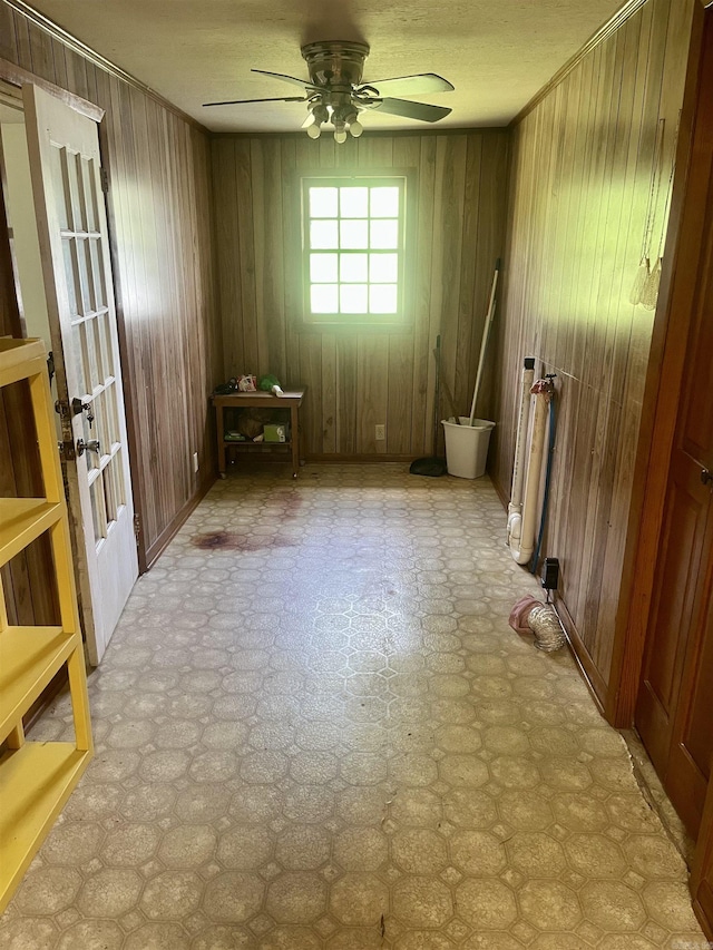unfurnished room featuring french doors, tile patterned floors, wood walls, and ceiling fan