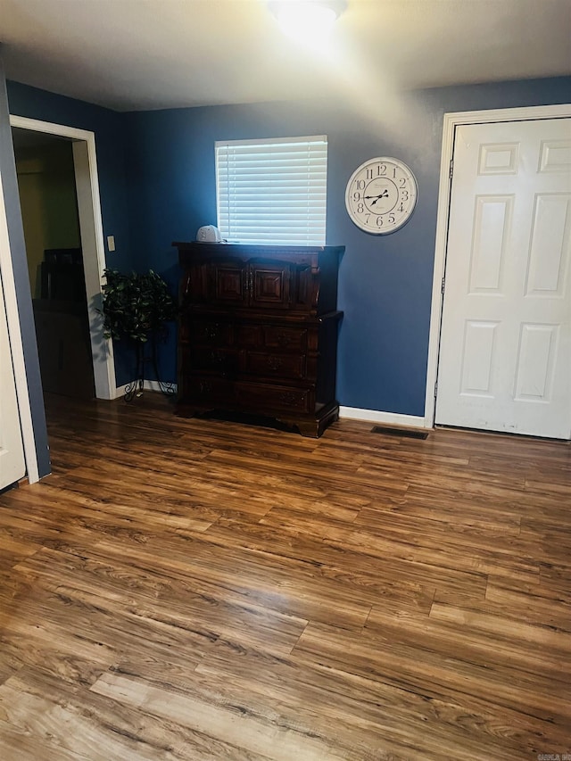 interior space featuring visible vents, baseboards, and wood finished floors