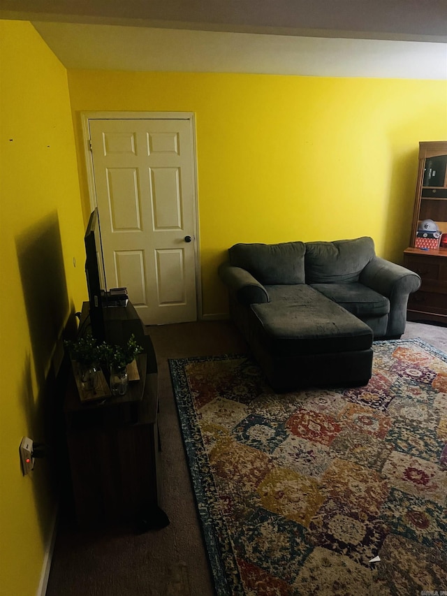 carpeted living area with baseboards