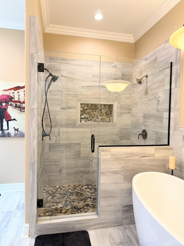 full bath with ornamental molding, a shower stall, and a freestanding bath