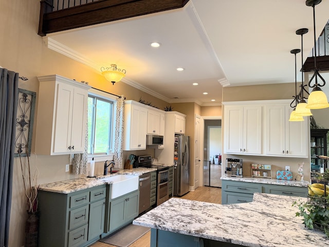kitchen featuring recessed lighting, white cabinetry, stainless steel appliances, light wood finished floors, and a sink