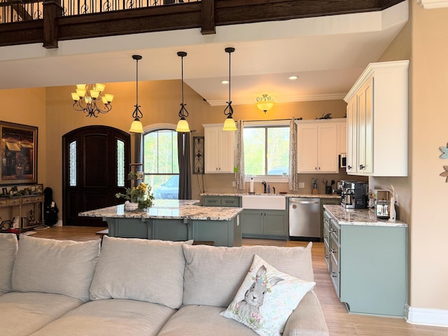 kitchen with dishwasher, open floor plan, a chandelier, white cabinetry, and light wood finished floors