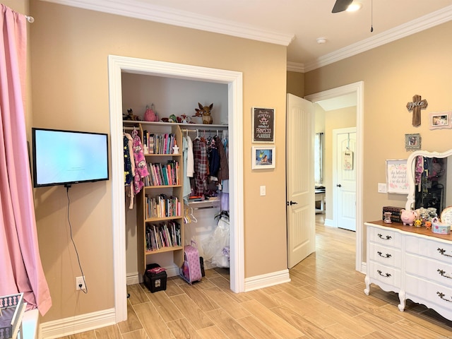 bedroom with crown molding, a closet, baseboards, and light wood finished floors