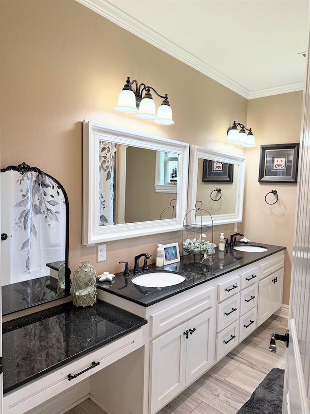 bathroom with double vanity, a sink, ornamental molding, and wood finished floors