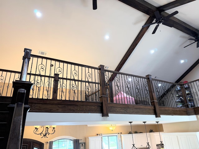 interior details featuring visible vents, ceiling fan, and beam ceiling
