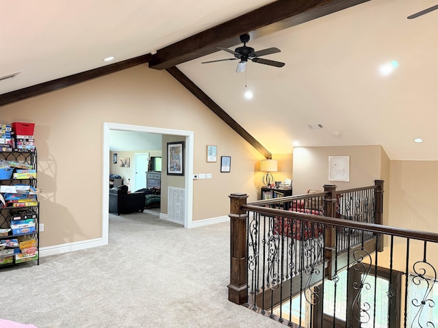 corridor featuring baseboards, lofted ceiling with beams, an upstairs landing, carpet floors, and visible vents