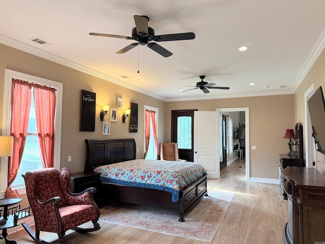 bedroom with light wood finished floors, visible vents, ornamental molding, and ceiling fan