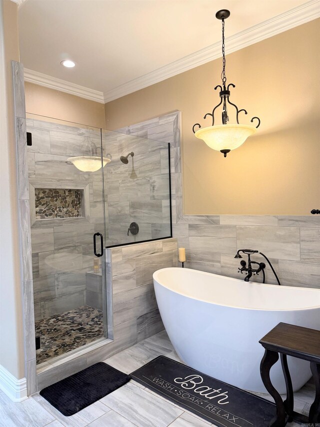 bathroom featuring crown molding, tile walls, a freestanding bath, and a stall shower