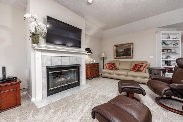 13 Arista Ln, Hot Springs Village, AR 71909 - living area featuring a textured ceiling, vaulted ceiling, carpet floors, a tile fireplace, and baseboards