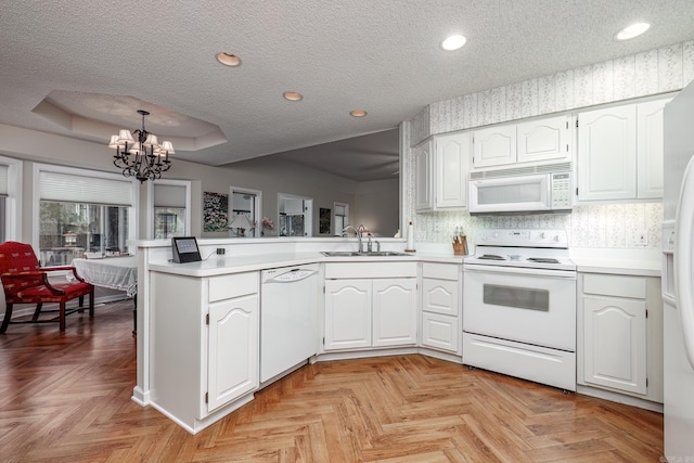 13 Arista Ln, Hot Springs Village, AR 71909 - kitchen with an inviting chandelier, white appliances, a peninsula, a textured ceiling, and a sink