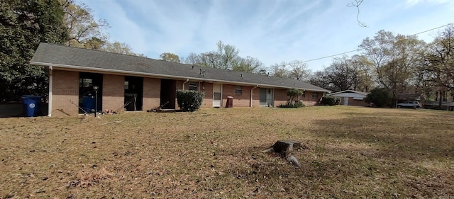 1019 Amanda St, Camden, AR 71701 - back of house with brick siding and a yard