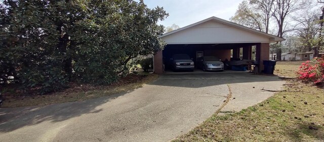 1019 Amanda St, Camden, AR 71701 - garage with concrete driveway and a carport