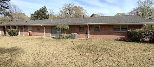 1019 Amanda St, Camden, AR 71701 - rear view of house featuring brick siding, cooling unit, and a lawn