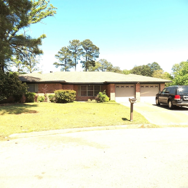 7 Laffite Cv, Pine Bluff, AR 71603 - ranch-style home with an attached garage, driveway, a front yard, and brick siding