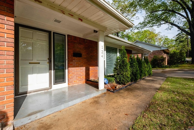 124 Hiawatha Dr, Little Rock, AR 72211 - property entrance featuring a porch and brick siding