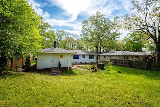 124 Hiawatha Dr, Little Rock, AR 72211 - rear view of property with crawl space, fence, and a lawn
