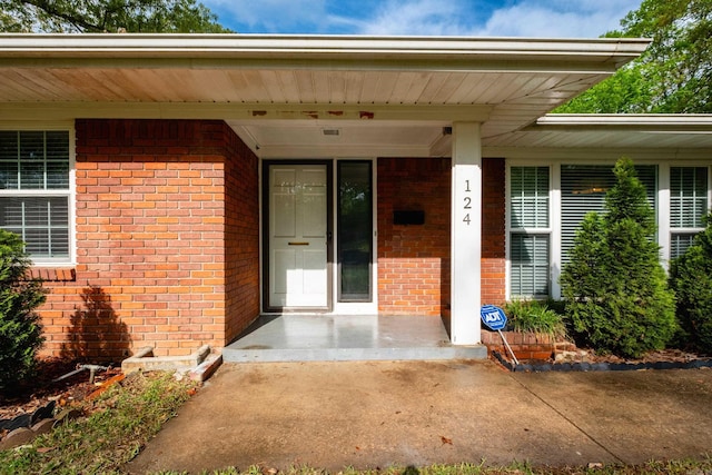 124 Hiawatha Dr, Little Rock, AR 72211 - doorway to property with covered porch and brick siding