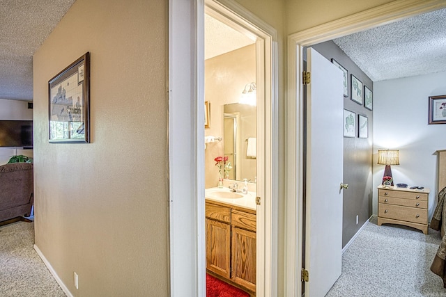 20 Cortez Way, Hot Springs Village, AR 71909 - corridor with a sink, carpet floors, baseboards, and a textured ceiling