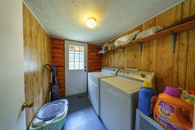 laundry room with washer and dryer, rustic walls, laundry area, and a textured ceiling
