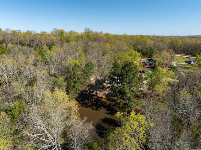 drone / aerial view featuring a forest view