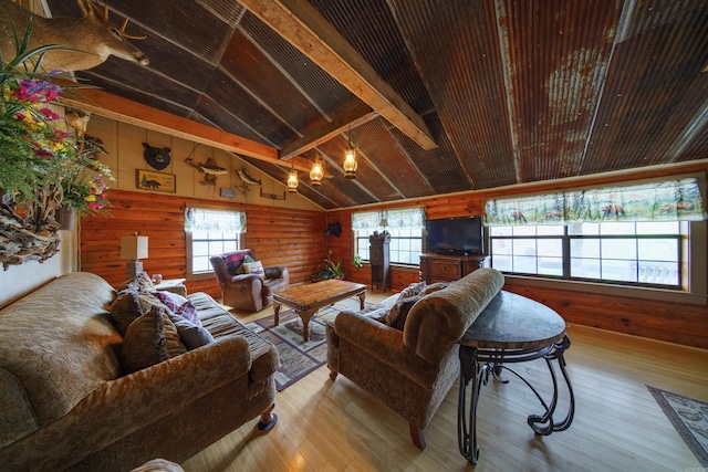 living room with wood walls, wood-type flooring, and vaulted ceiling with beams
