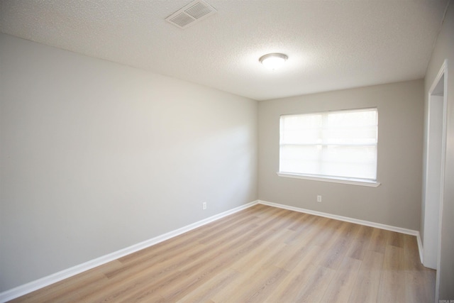 28 Wellford Dr, Little Rock, AR 72209 - unfurnished room featuring light wood-style floors, baseboards, visible vents, and a textured ceiling