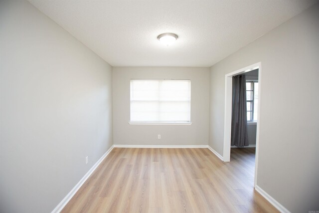28 Wellford Dr, Little Rock, AR 72209 - unfurnished room with light wood-type flooring, baseboards, and a textured ceiling