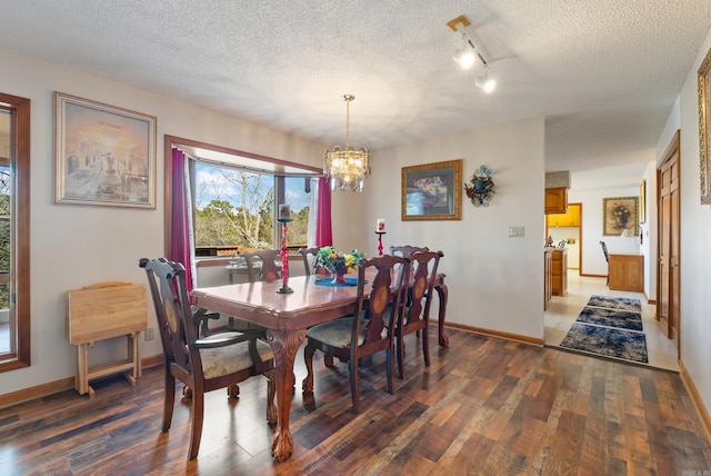 dining area featuring wood-type flooring, baseboards, and a notable chandelier