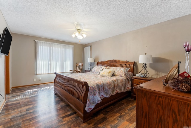 bedroom with dark wood-type flooring, baseboards, a ceiling fan, and a textured ceiling