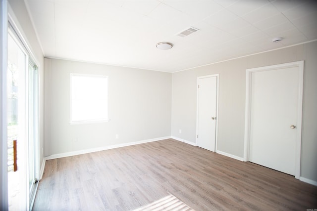 7204 W Wakefield Dr, Little Rock, AR 72209 - empty room with wood finished floors, baseboards, visible vents, and a wealth of natural light