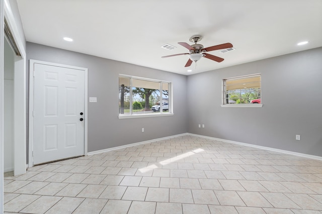 spare room with a wealth of natural light, recessed lighting, visible vents, and a ceiling fan