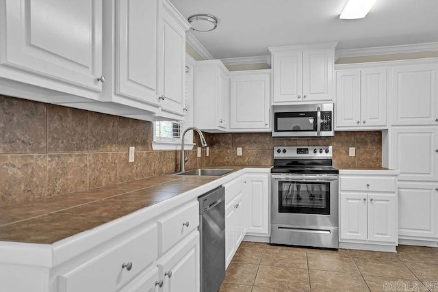 2540 Gladiola, Conway, AR 72034 - kitchen featuring light tile patterned floors, a sink, white cabinets, and stainless steel appliances