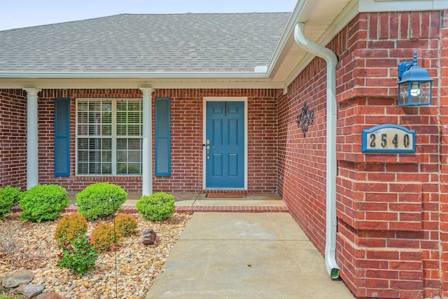2540 Gladiola, Conway, AR 72034 - view of exterior entry with brick siding, covered porch, and roof with shingles