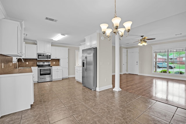 2540 Gladiola, Conway, AR 72034 - kitchen with appliances with stainless steel finishes, light tile patterned floors, visible vents, decorative backsplash, and a sink