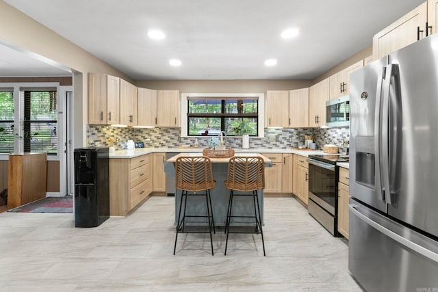 16 Valley Rd, Cabot, AR 72023 - kitchen with light countertops, decorative backsplash, light brown cabinets, and stainless steel appliances