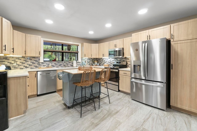 16 Valley Rd, Cabot, AR 72023 - kitchen featuring a kitchen breakfast bar, light countertops, a sink, stainless steel appliances, and light brown cabinets