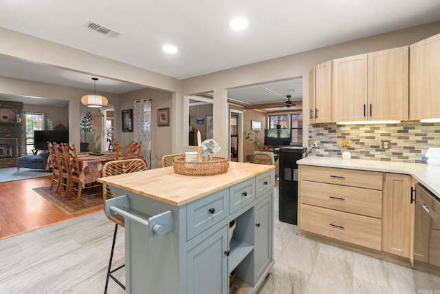 16 Valley Rd, Cabot, AR 72023 - kitchen featuring visible vents, a breakfast bar area, light brown cabinets, and butcher block counters